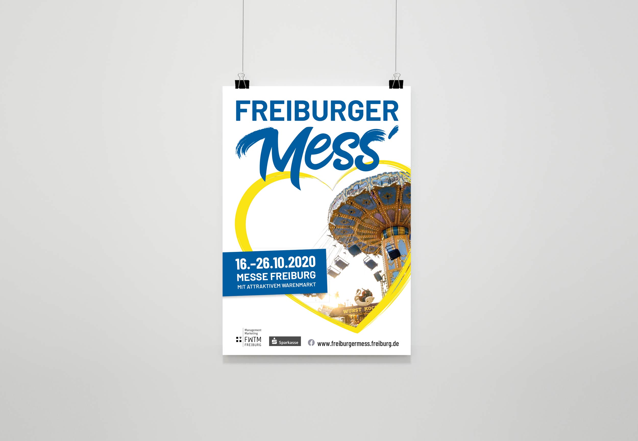Ansicht eines Plakats für die FWTM, welches vor einem weißen Hintergrund an Klammern hängt